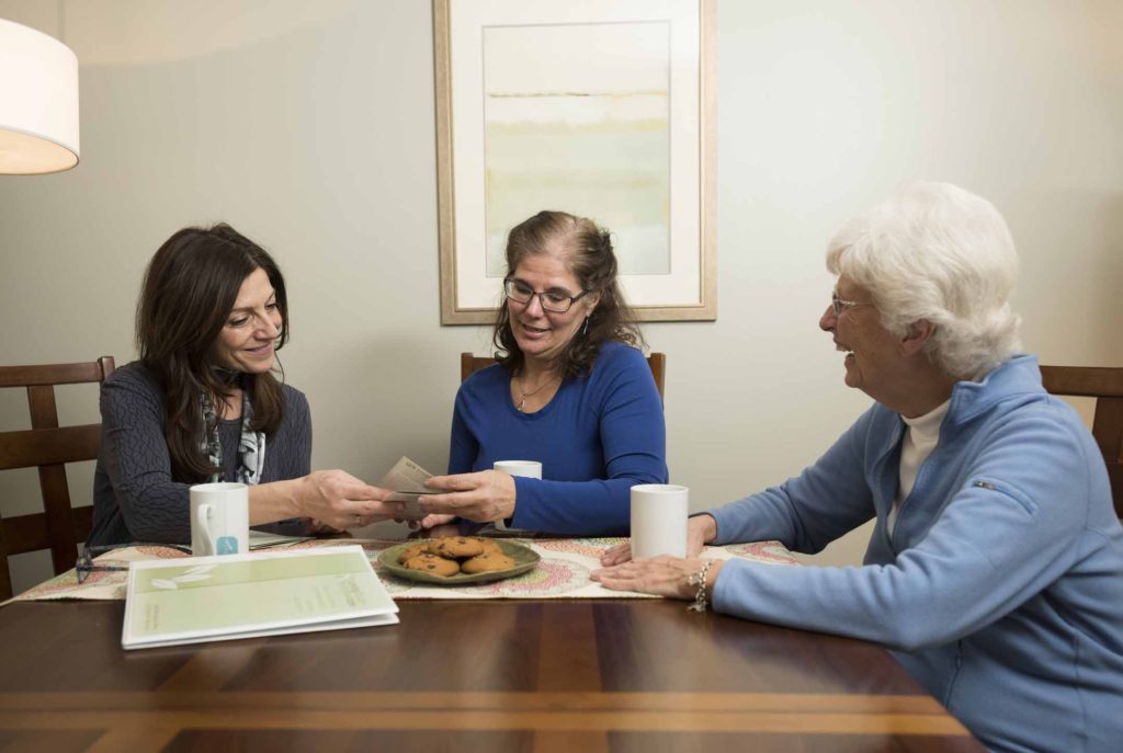 Caregiver consults with a client and her daughter. 